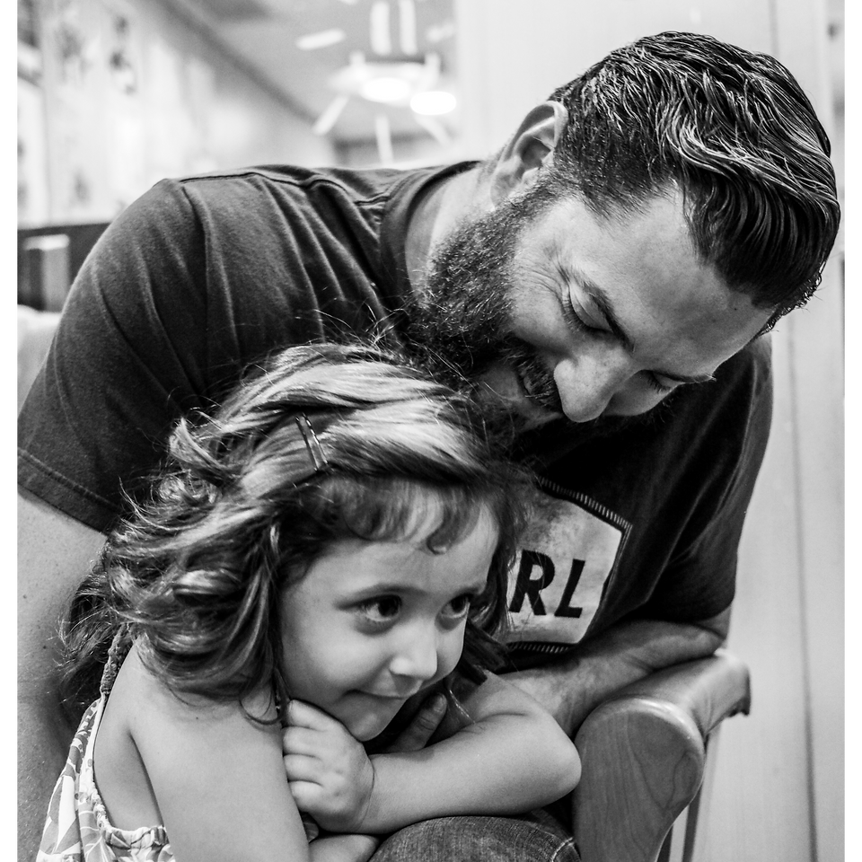 A caregiver father and his daughter smiling at RMH-NY